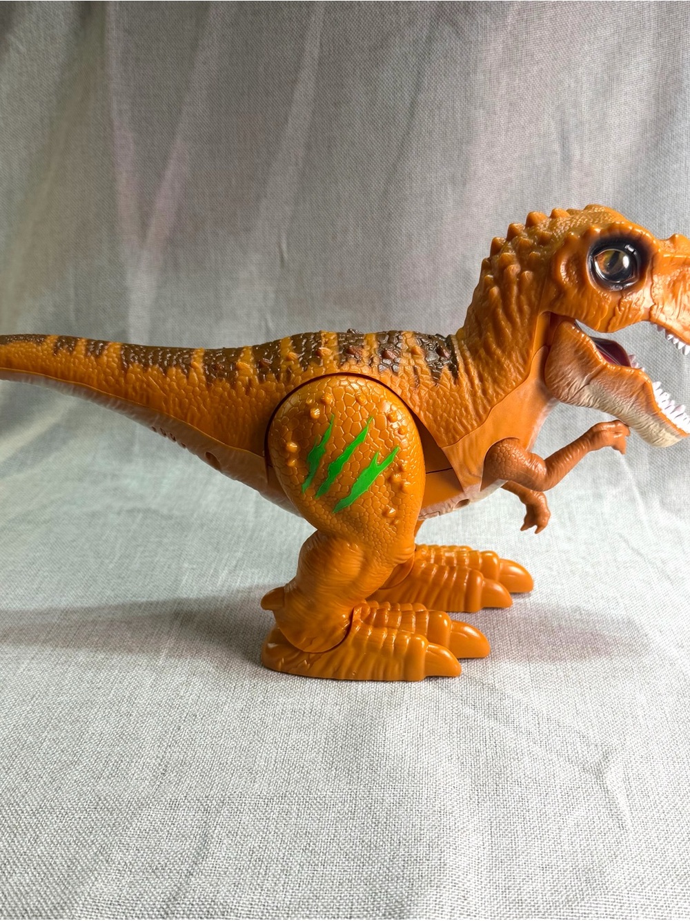Orange Dinosaur Toy with Green Claw Marks